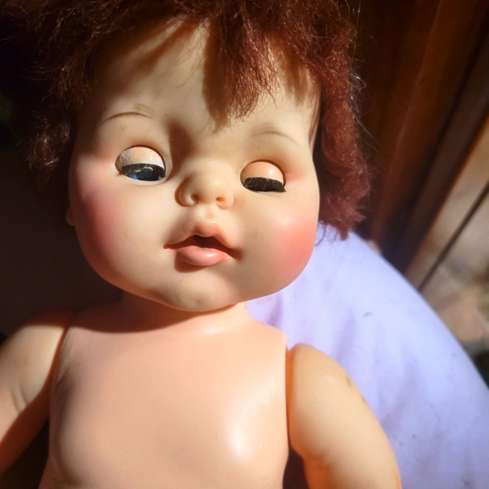 Late 80s plastic doll with red hair and eyes that close